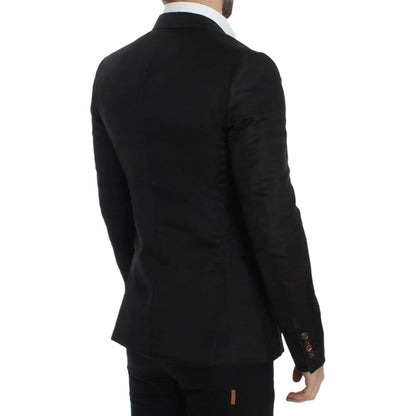 Back view of a man wearing a Dolce & Gabbana black silk slim fit blazer, showcasing its stylish design and fit.