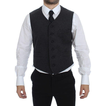 Dolce Gabbana gray wool blend vest shown on model, featuring a single breasted design with adjustable back waist strap.